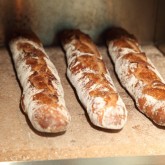 Baguettes ready to be taken out of the stone oven