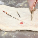 Cutting the fougasse dough