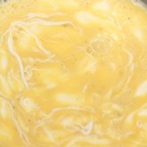 Mixing eggs, milk and crème fraîche