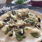 Pizza with grilled aubergines, mozzarella, parmesan and jalapeño pesto