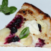 Sweet pizza with  crème fraîche lemon curd base, blueberries and white peach and fresh  basil